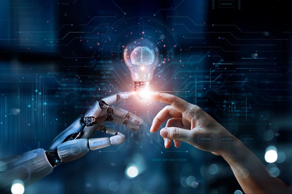Robot and human hands touching lightbulb.