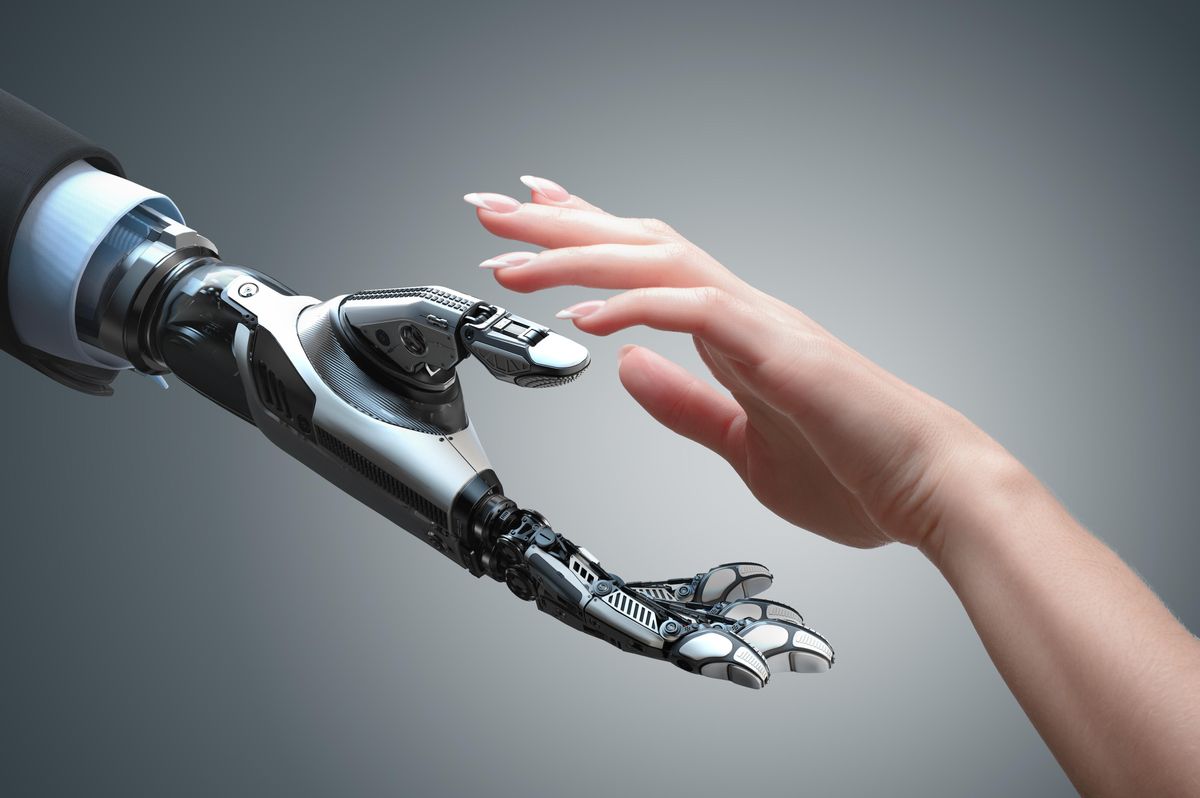 robot hand and human hand reaching toward each other
