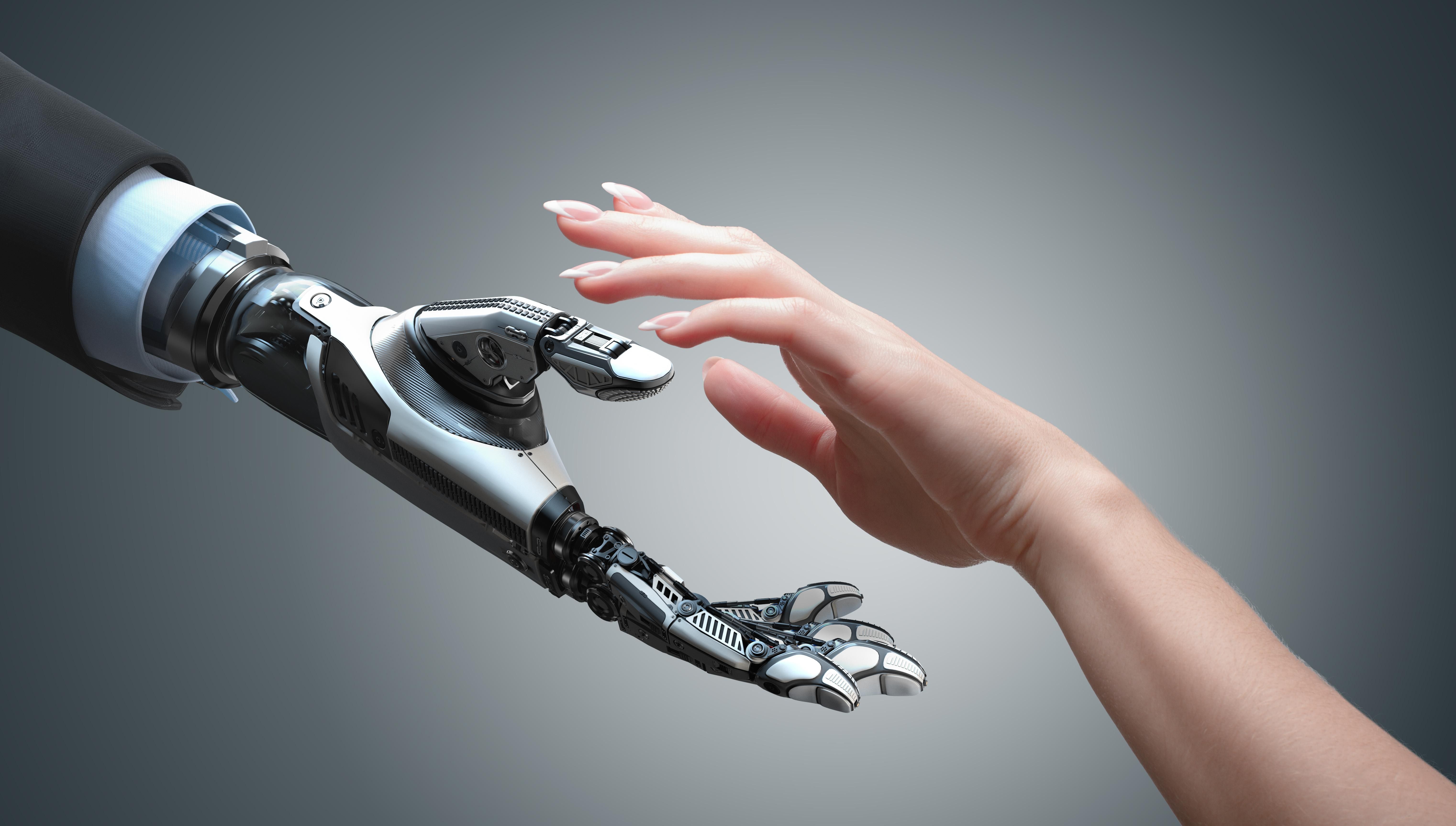 robot hand and human hand reaching toward each other