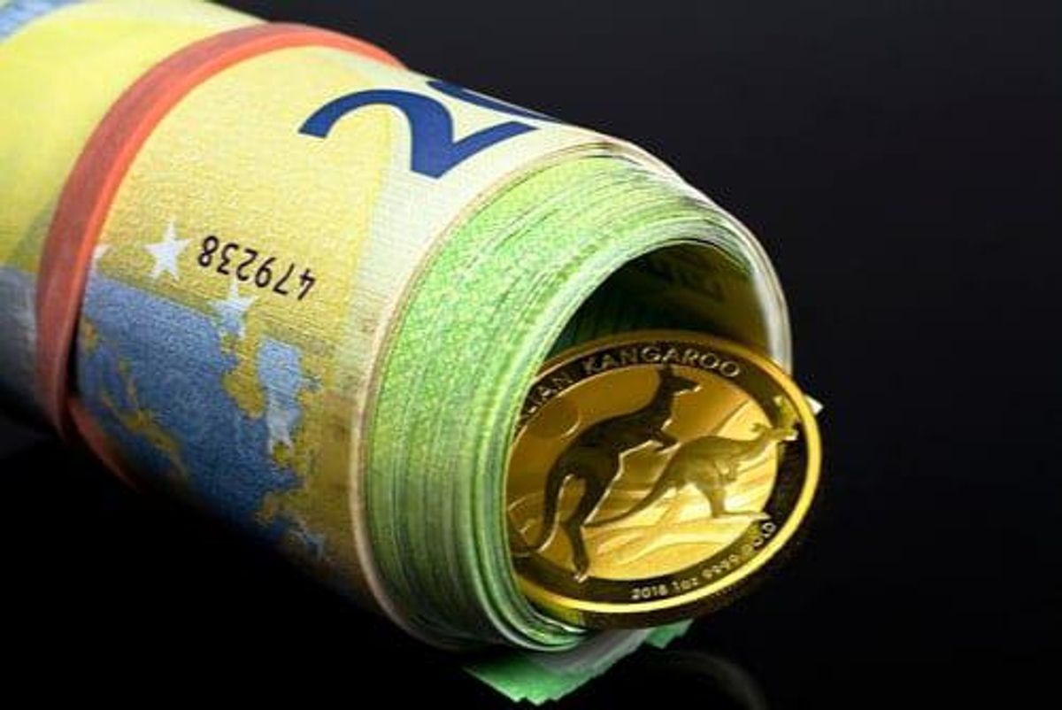 rolled up Australian dollars with gold ounce