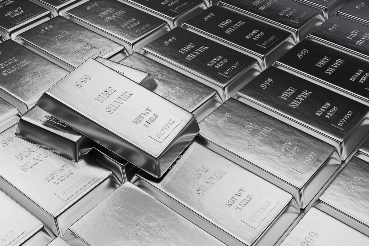 Rows of silver bars with two bars lying on top.