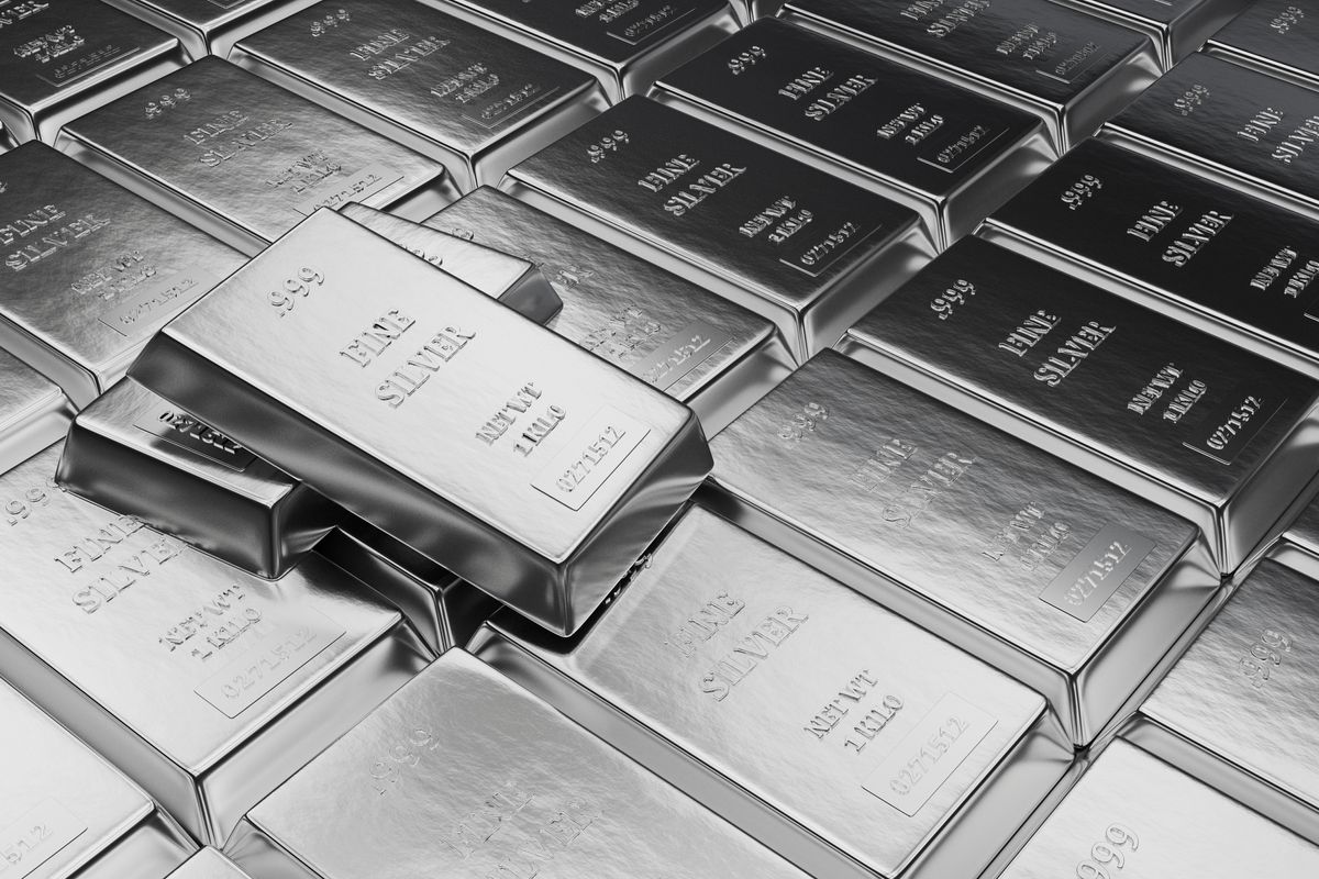 Rows of silver bars with two lying on top of them. 