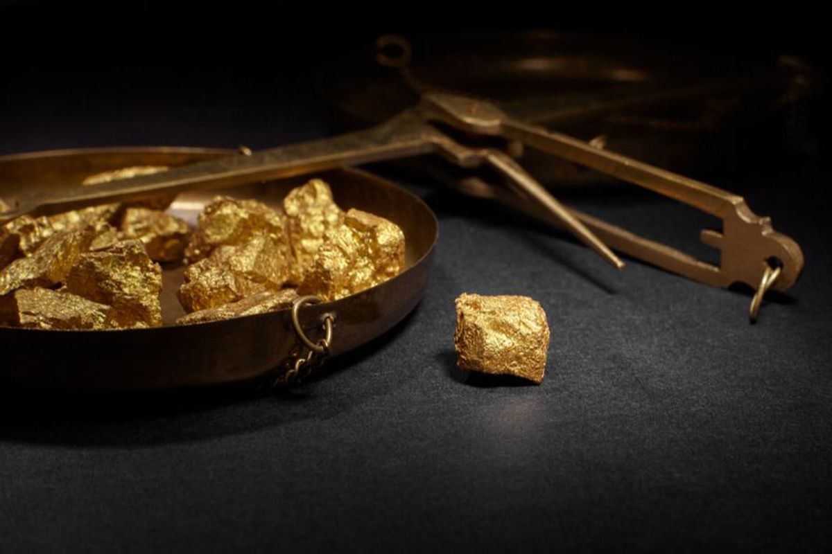 scale with gold nuggets lying down