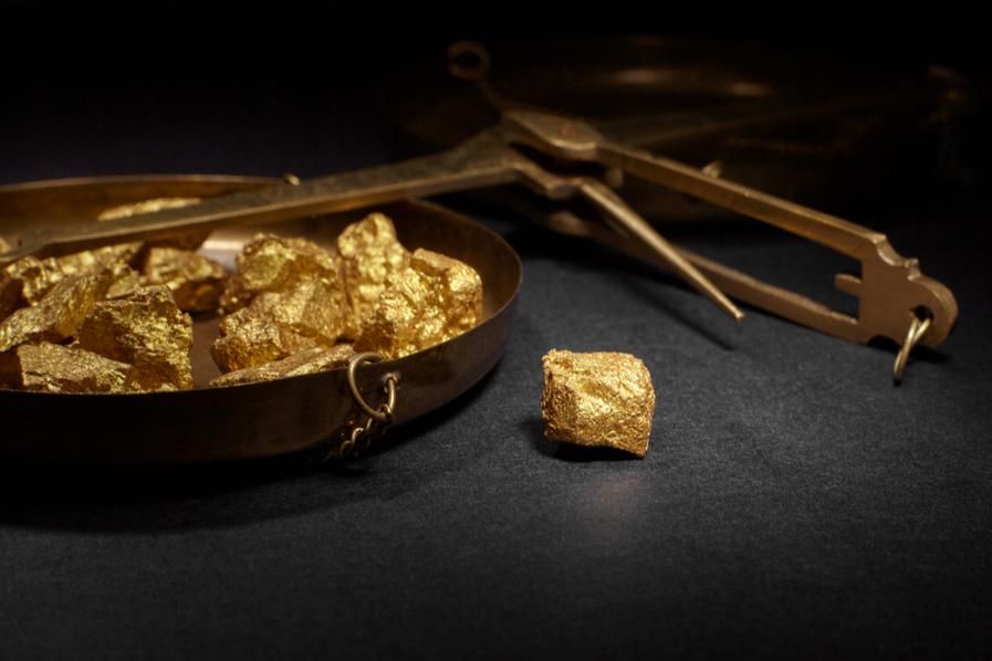 scale with gold nuggets lying down