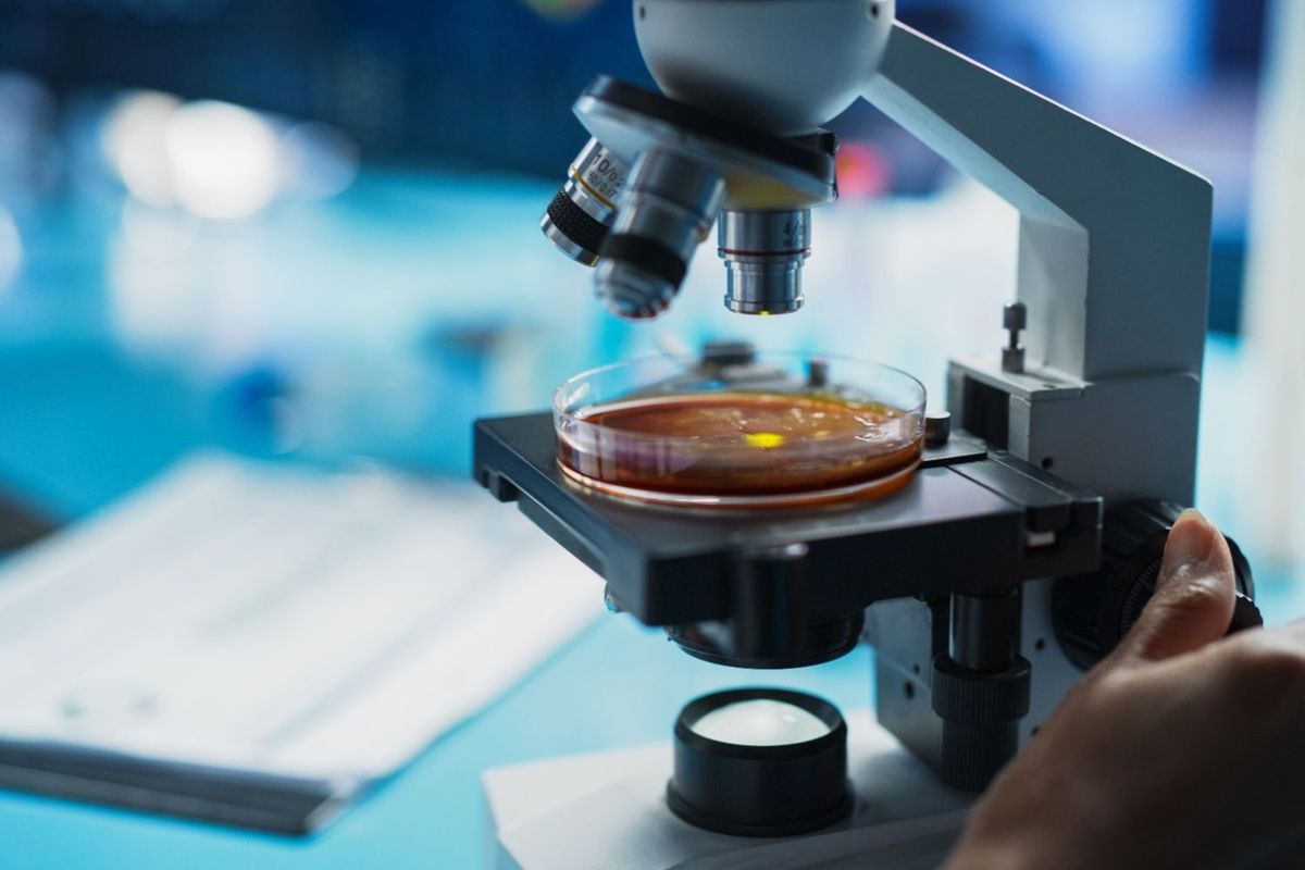 Scientist using microscope.