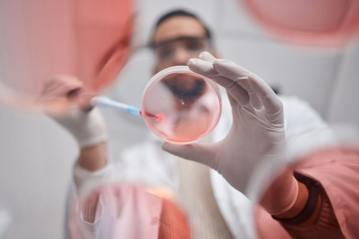 Scientist with petri dish.