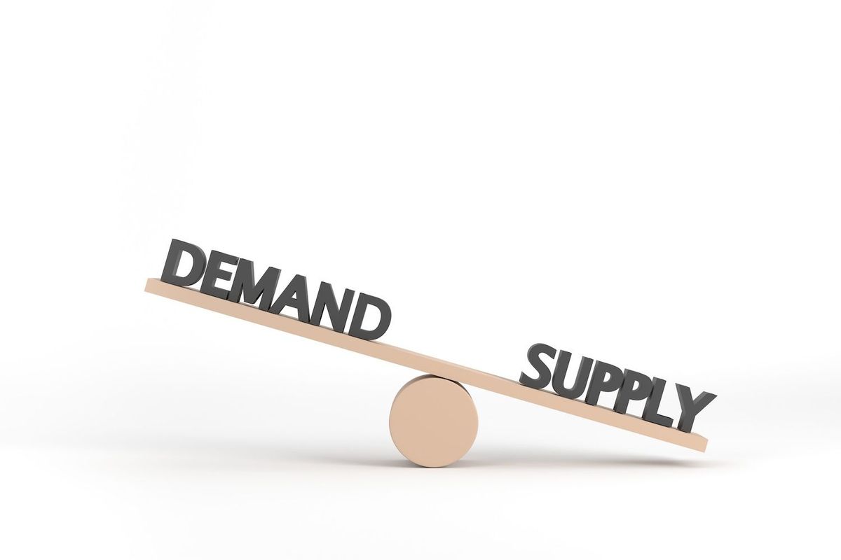 Seesaw with "demand" outweighing "supply," symbolizing economic imbalance.