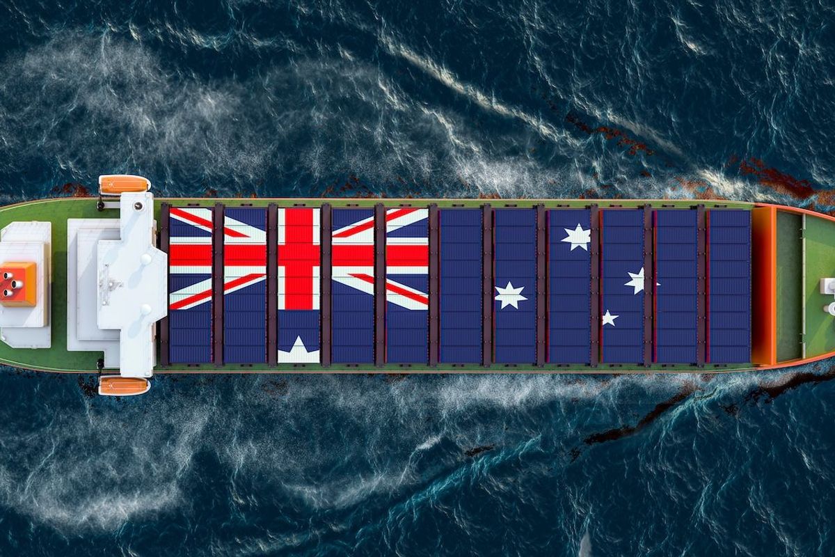 Ship carrying containers showing Australian flag.