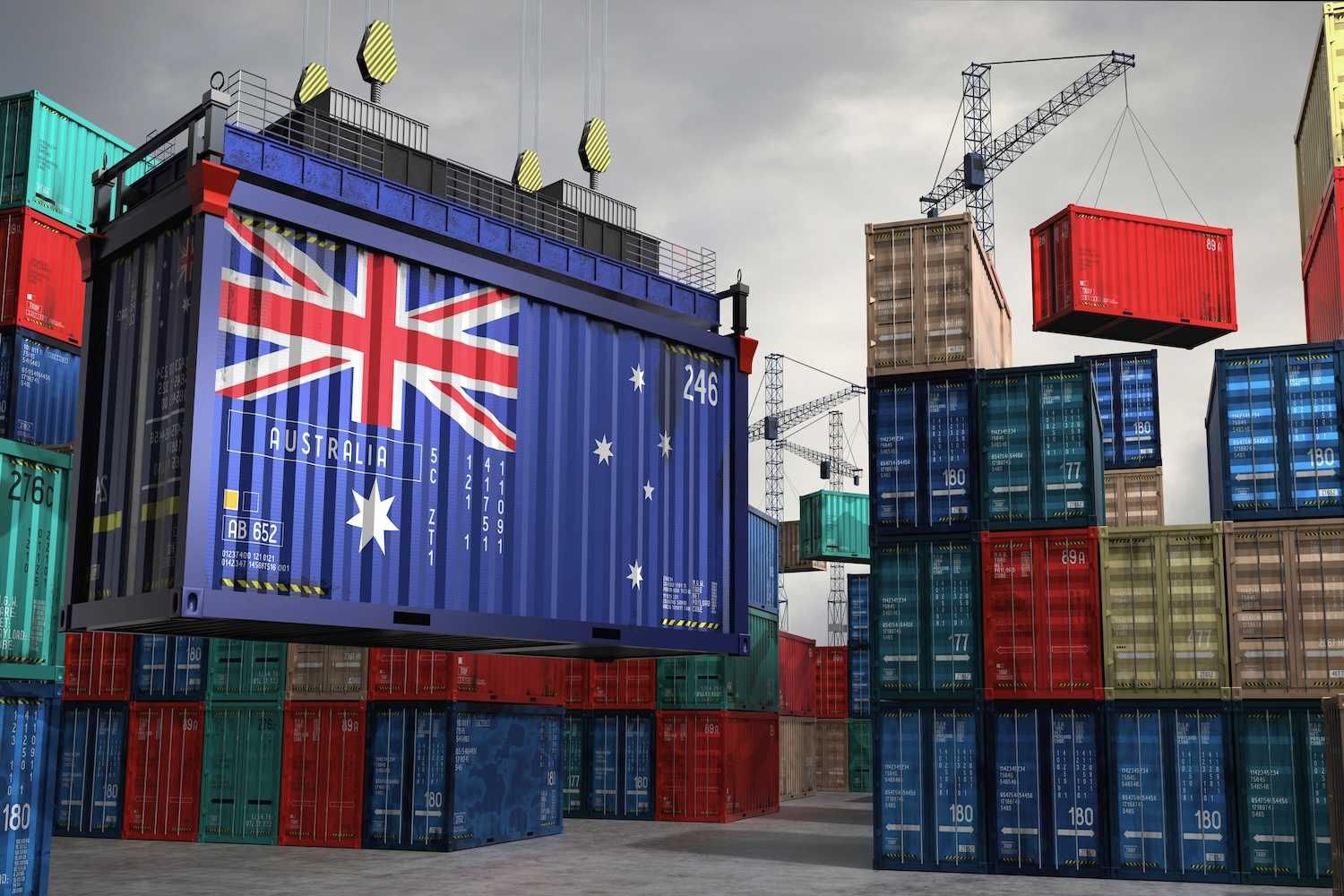 Shipping containers with cranes; one displays the Australian flag prominently.