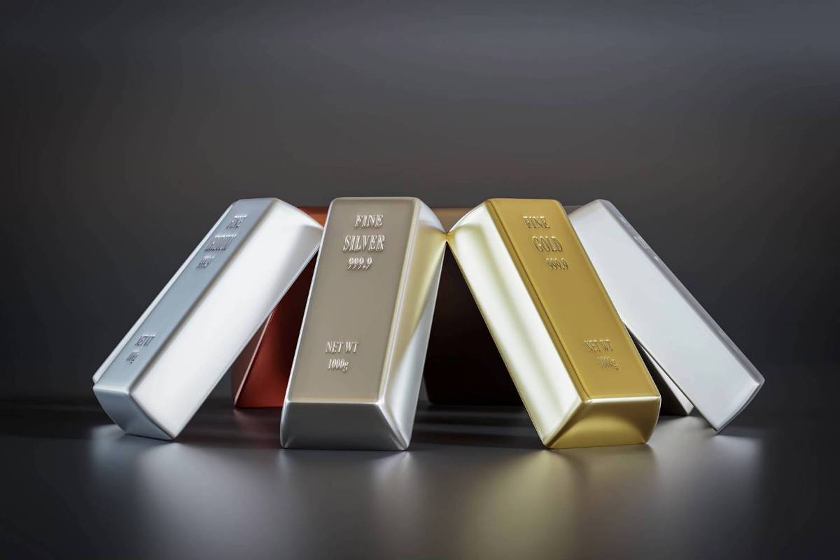 Silver and gold bars displayed on a dark surface.