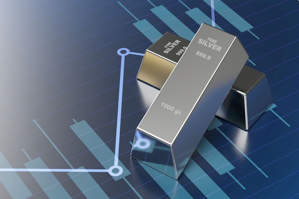 Silver bars on a financial chart background with upward trend lines.