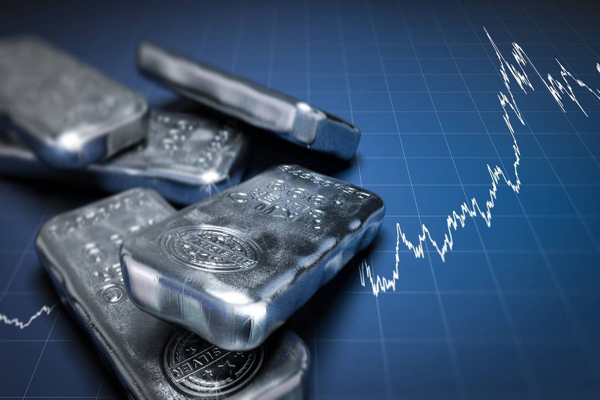 Silver bars on a graph background showing an upward trend line.