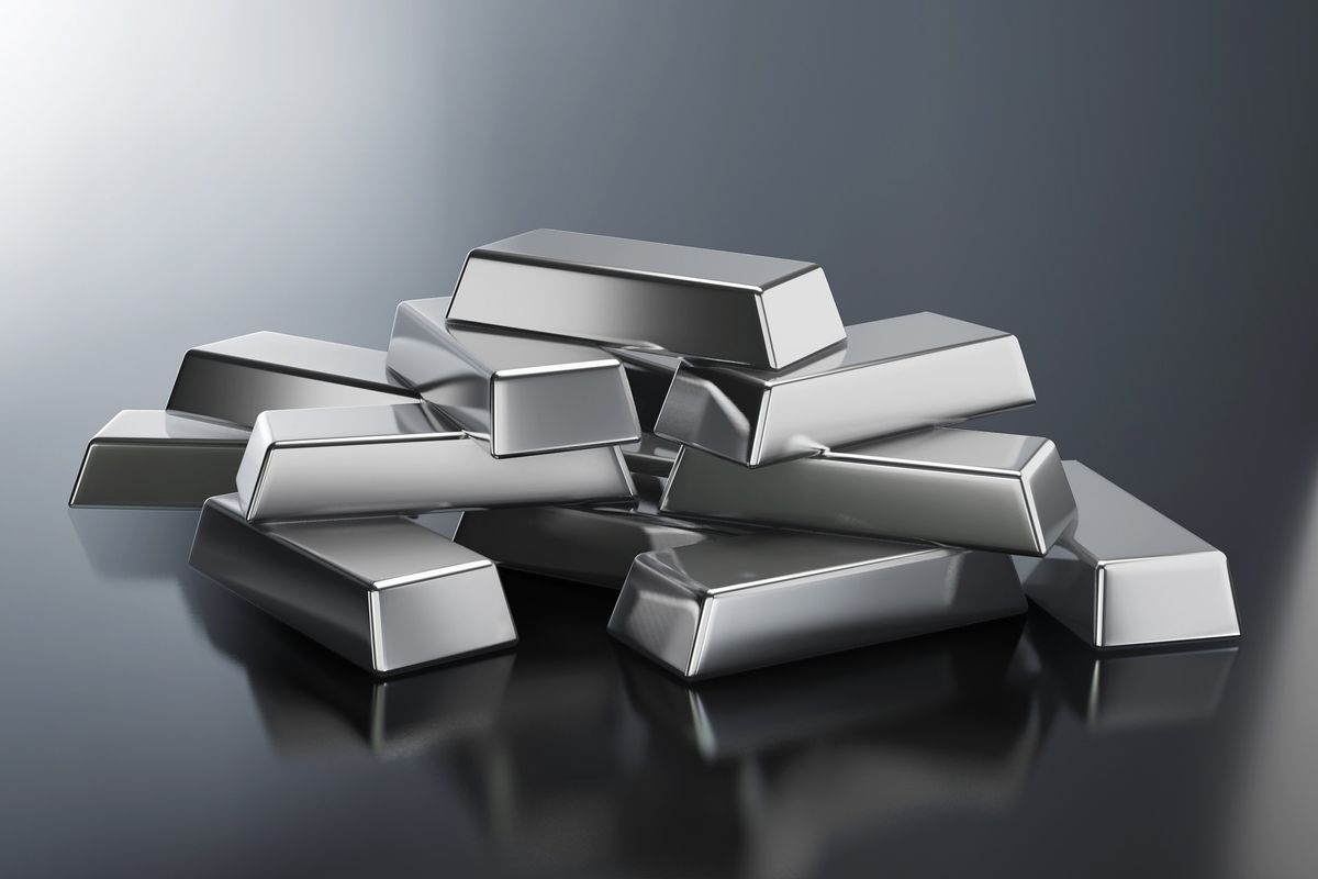 Silver bars on shiny metallic surface.