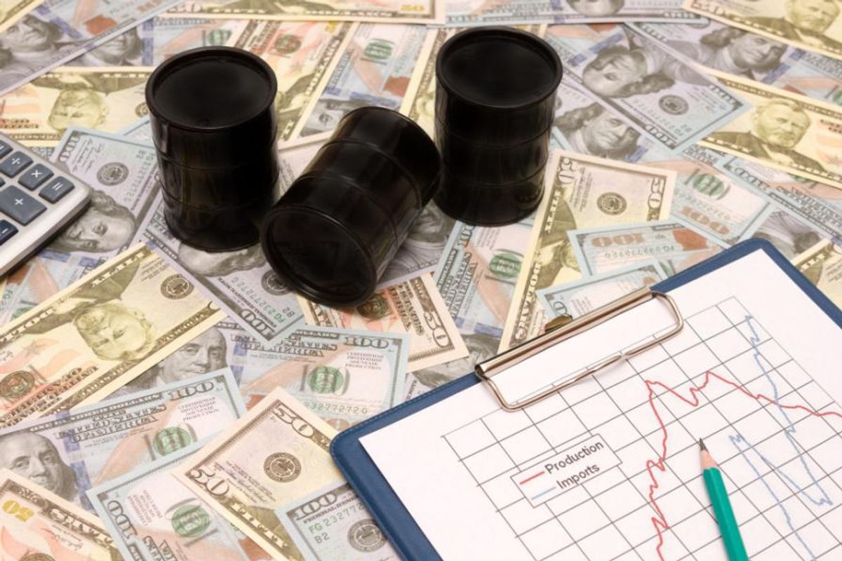 small oil barrels on top of US money