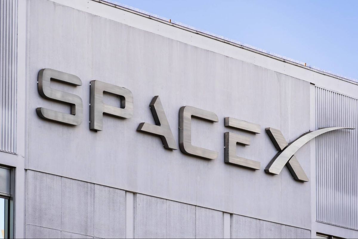 SpaceX building with blue sky above.
