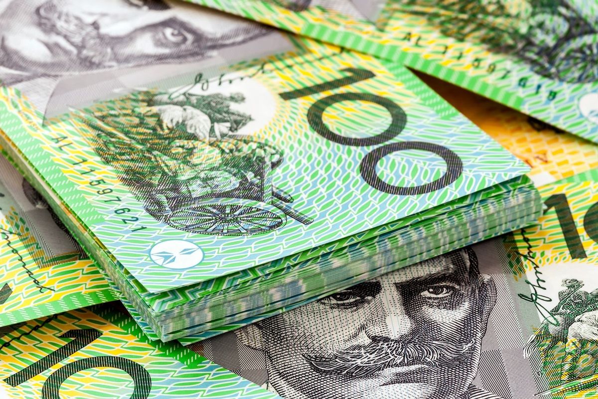 Stack of Australian $100 bills with green and yellow design.