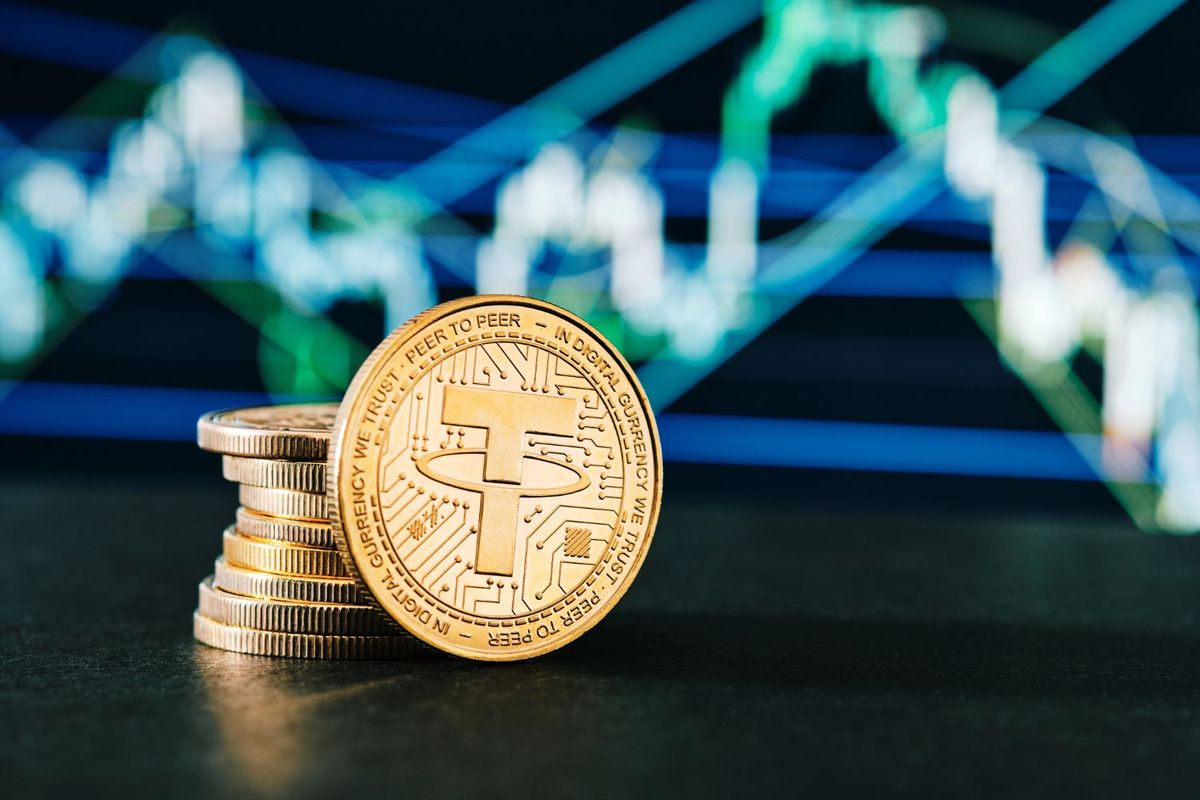 Stack of cryptocurrency coins with chart lines in the background.
