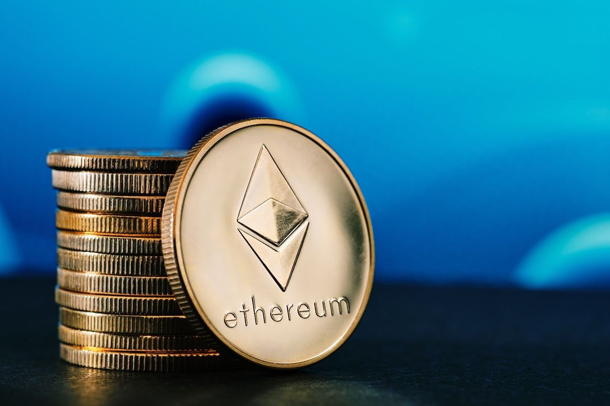 Stack of Ethereum coins against a blue background.