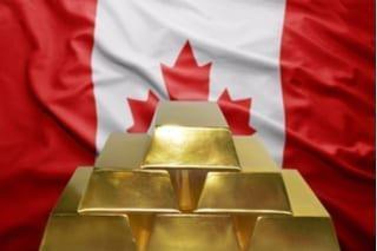 stack of gold bars in front of a Canadian flag