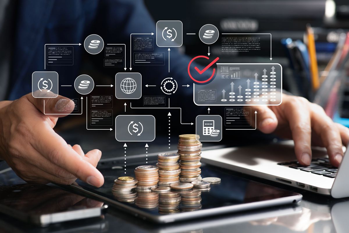 Stacked coins on a tablet with digital finance infographic overlay.