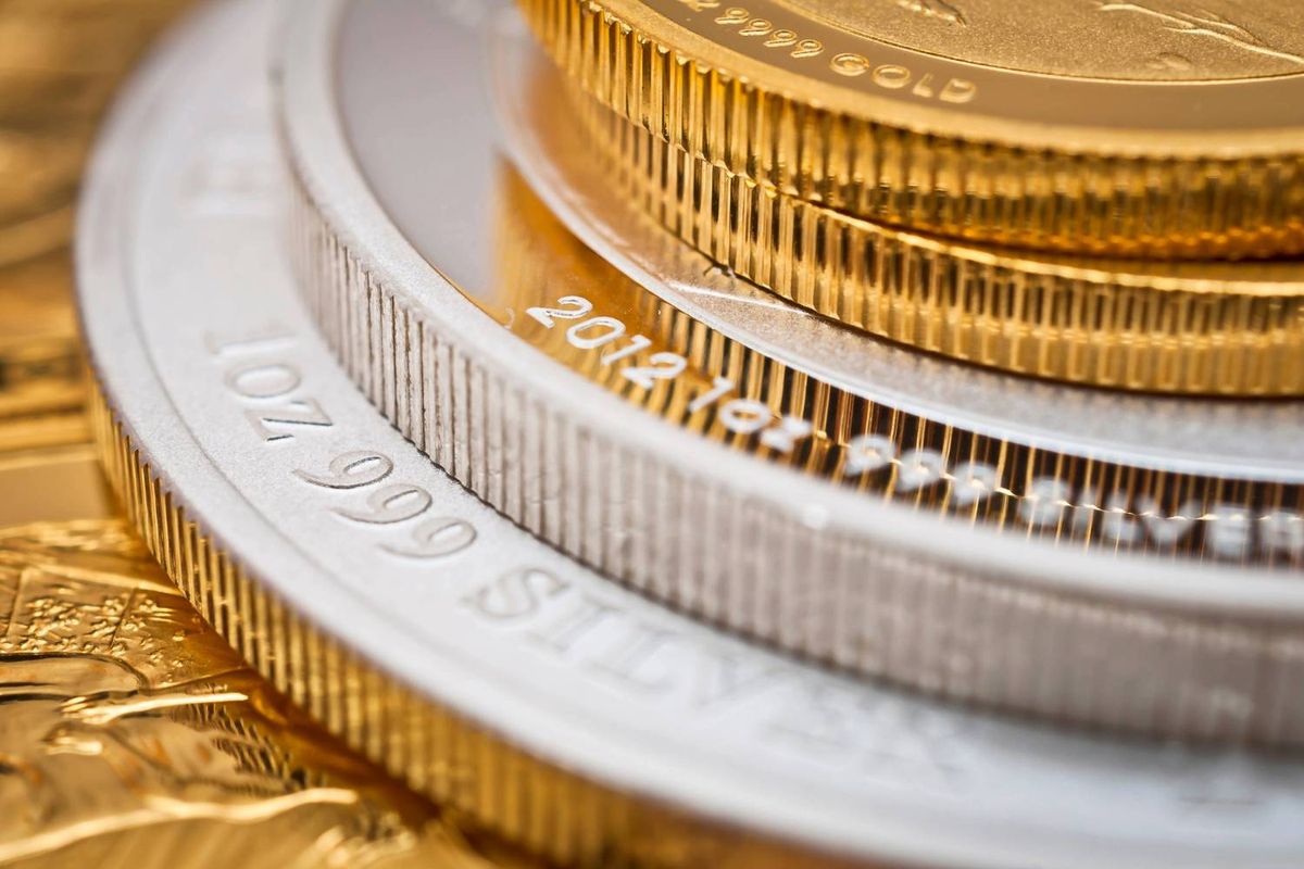 Stacked gold and silver coins with ribbed edges.