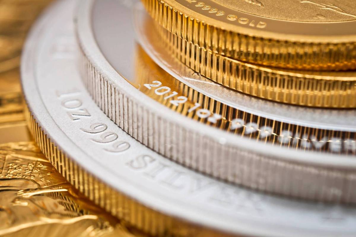Stacked gold and silver coins with ribbed edges.