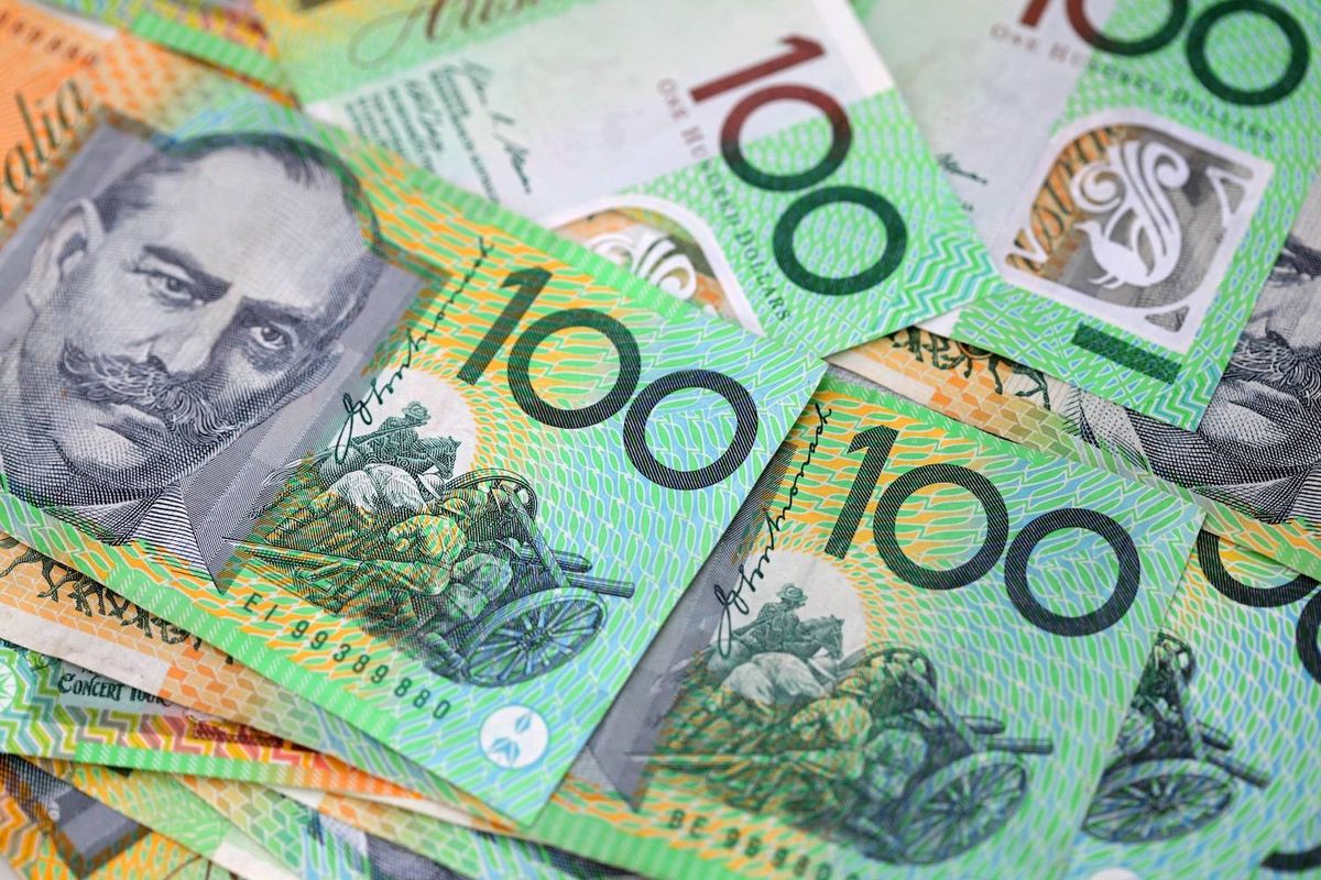 Stacks of Australian 100-dollar bills, colorful and detailed design.