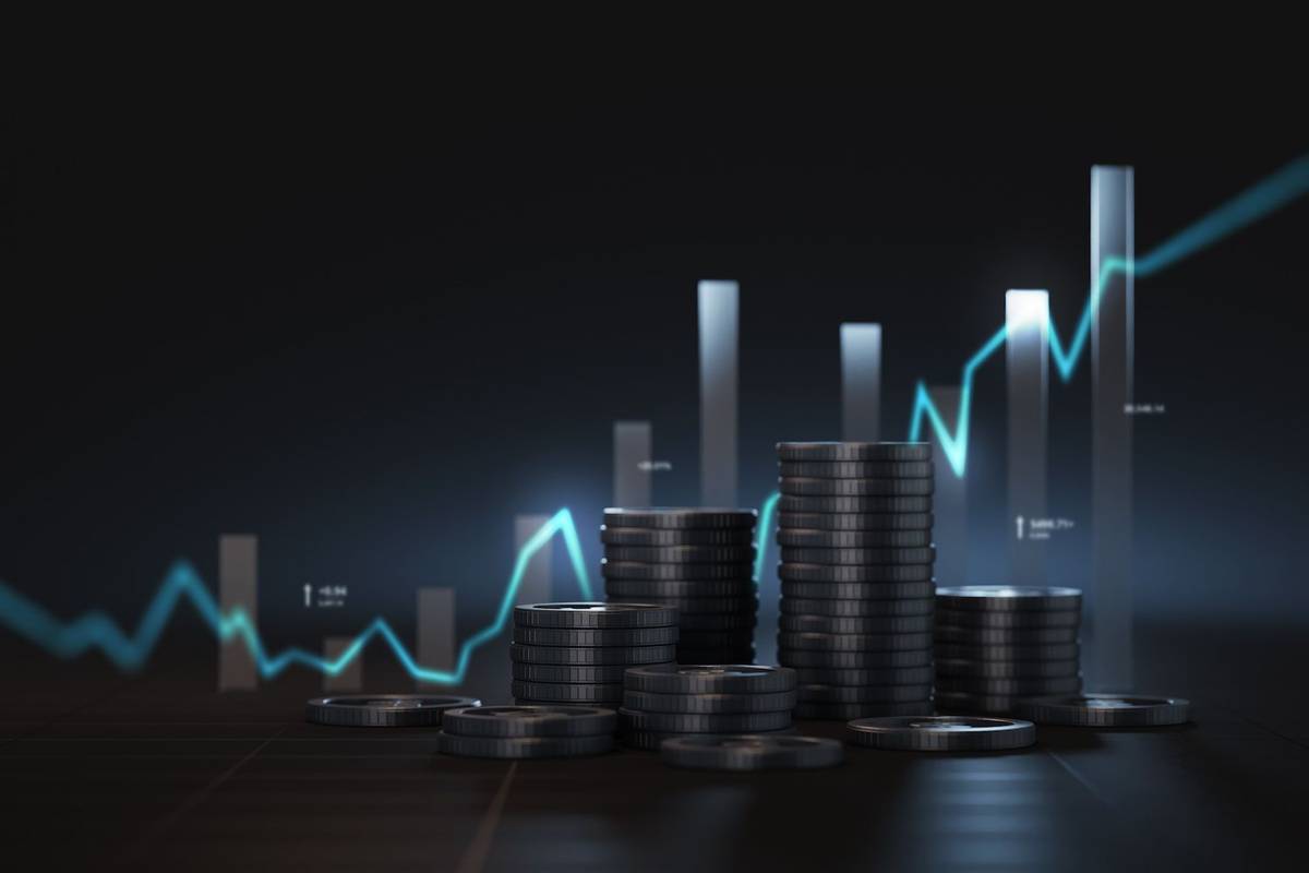 Stacks of coins in front of a rising graph on a dark background.