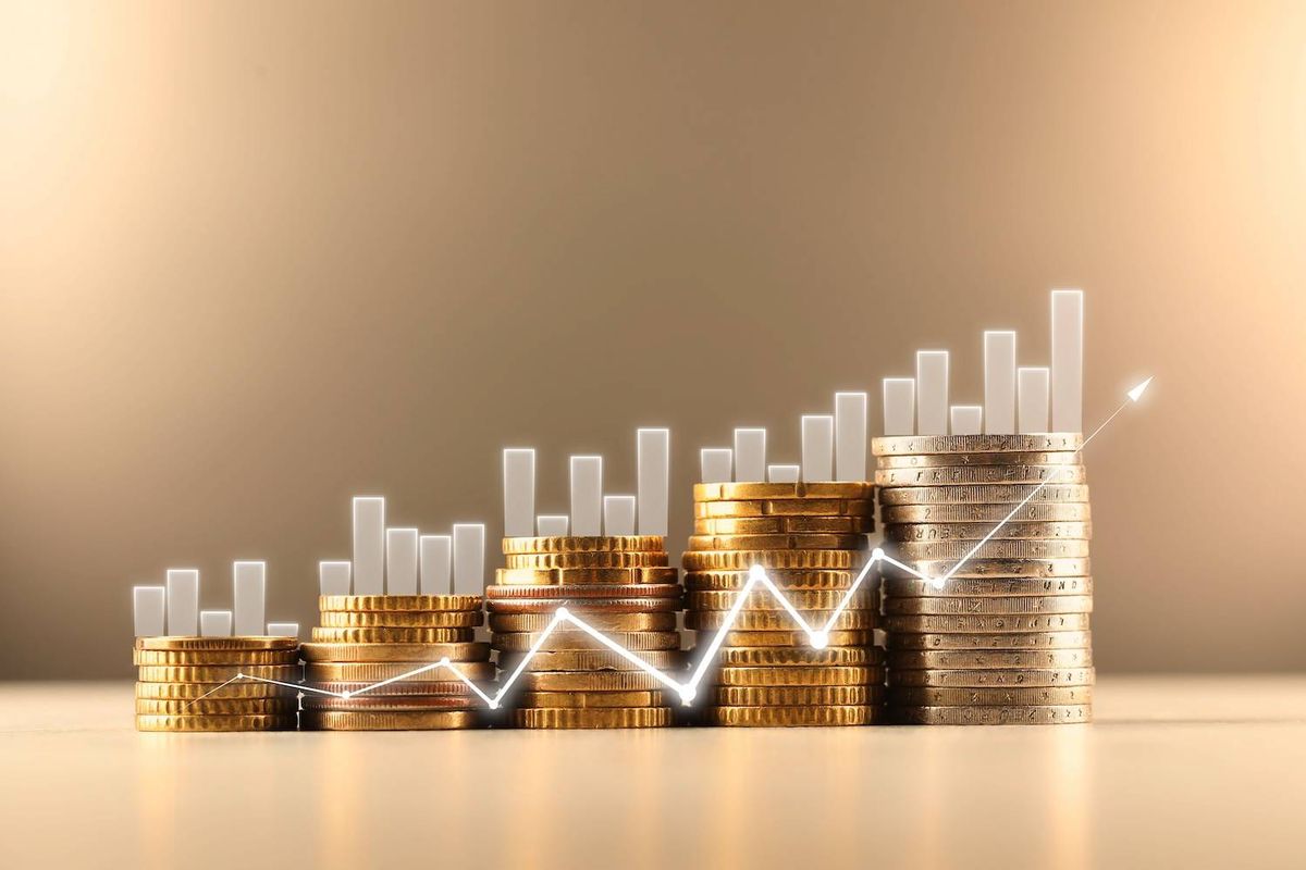 Stacks of coins with rising graph bars and upward trend line.