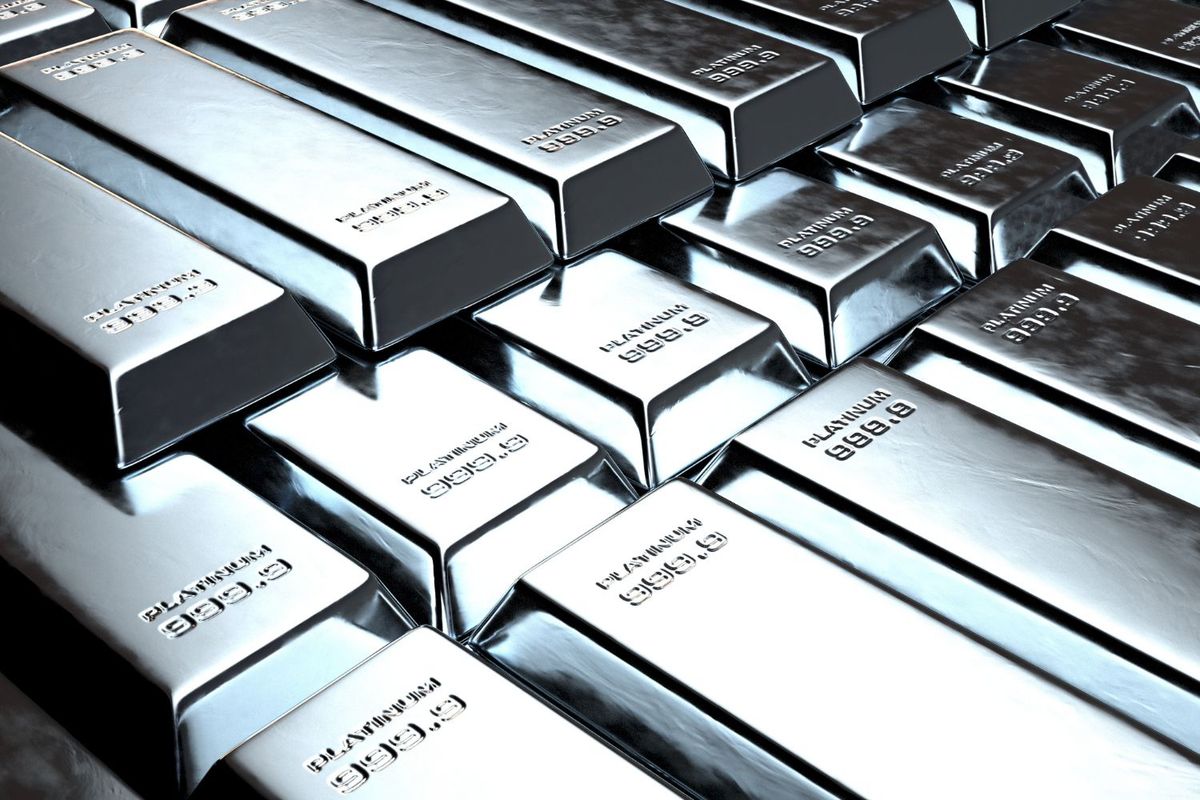 Stacks of shiny platinum bars with engravings.