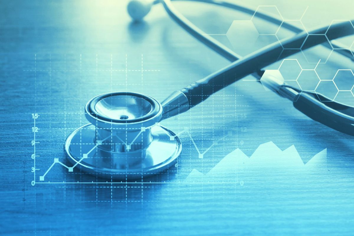 Stethoscope on desk with overlay of graphs and hexagonal patterns.