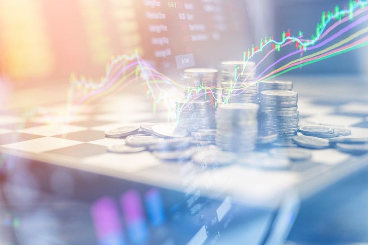 stock chart superimposed over laptop