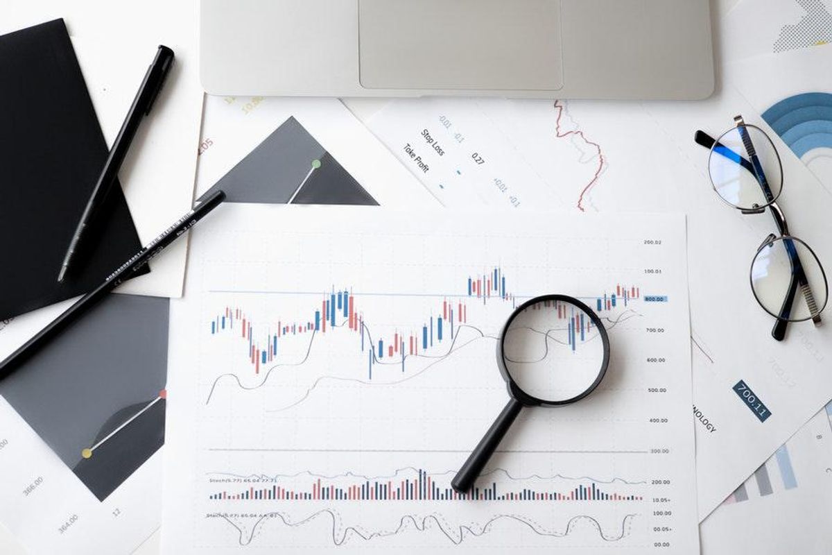 stock charts with magnifying glass