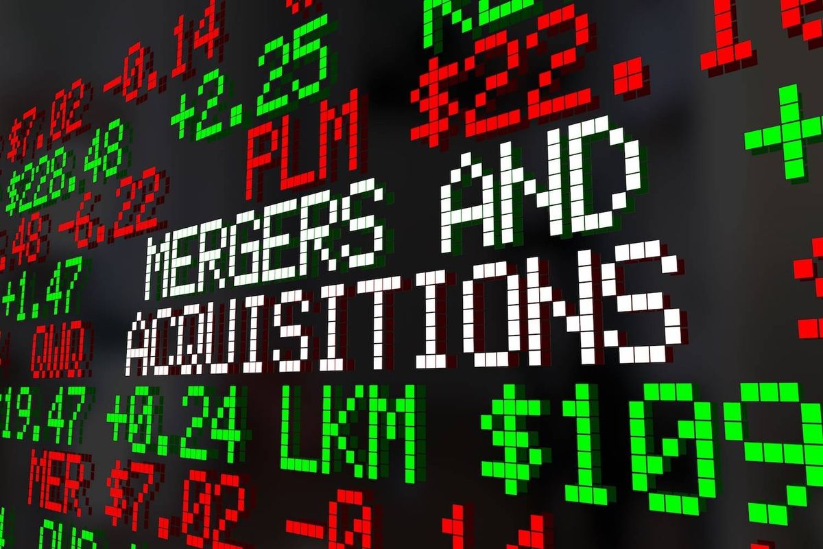 Stock market tickers with various numbers in red and green; text reads: "mergers and acquisitions."