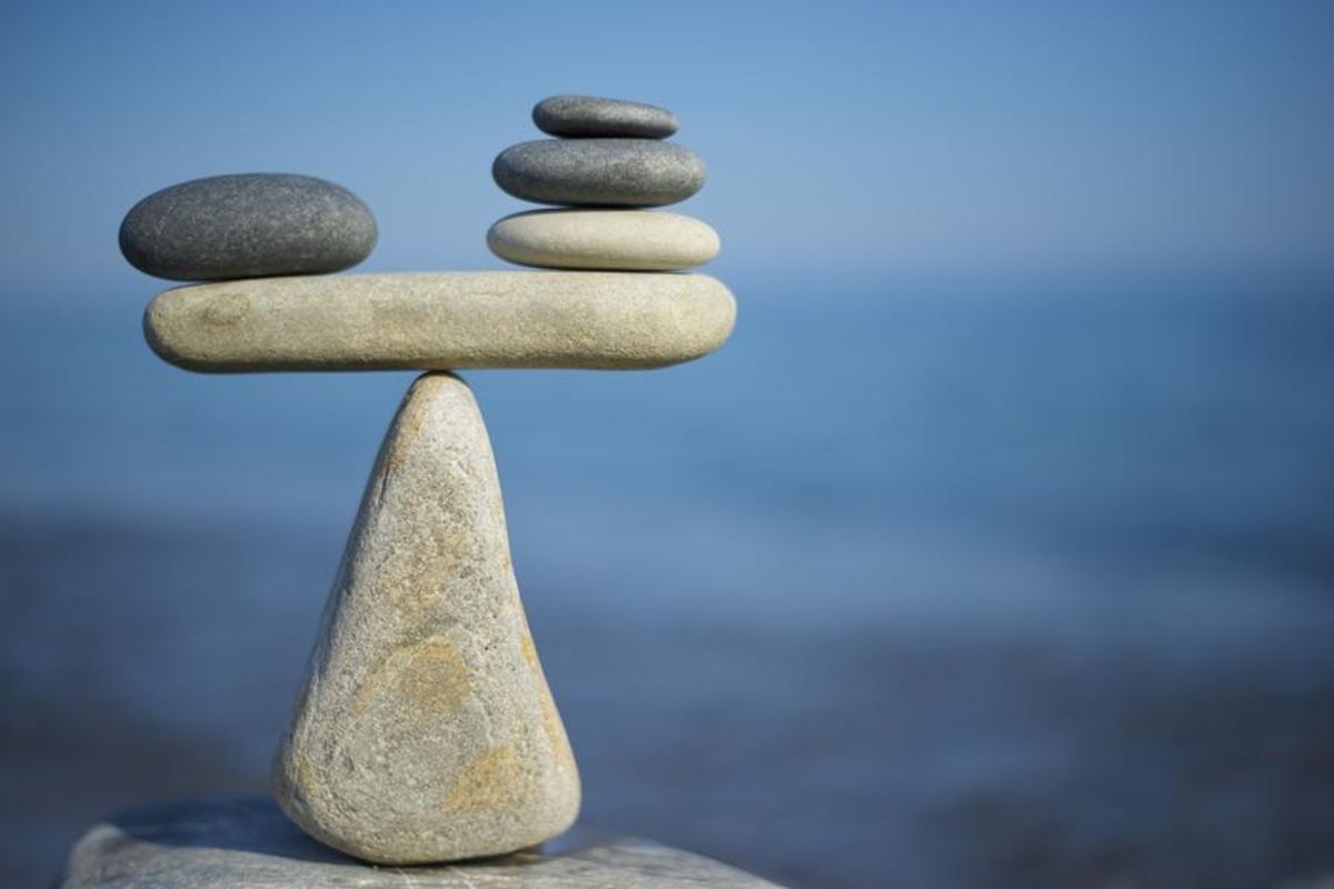 stones balancing with three smaller ones on one side and one larger one on the other