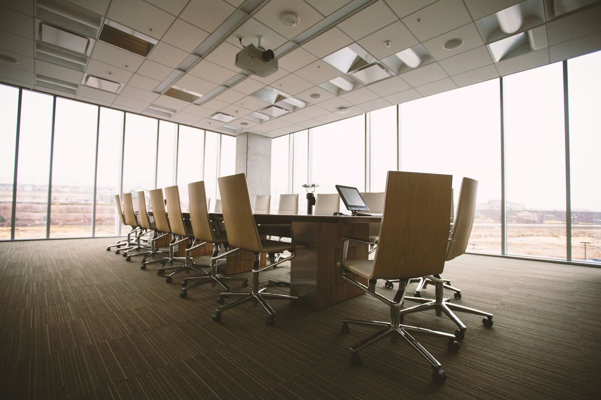 Table and chairs in boardroom.