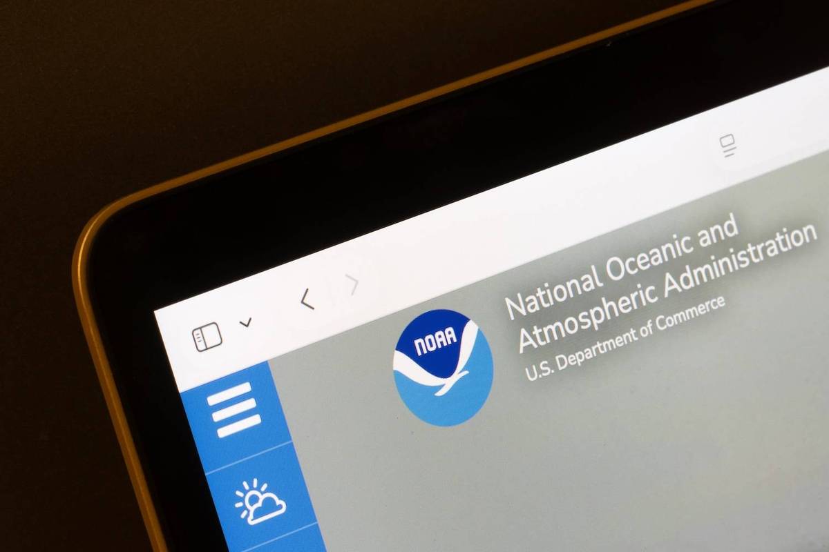 Tablet displaying NOAA website with blue logo on gray background.