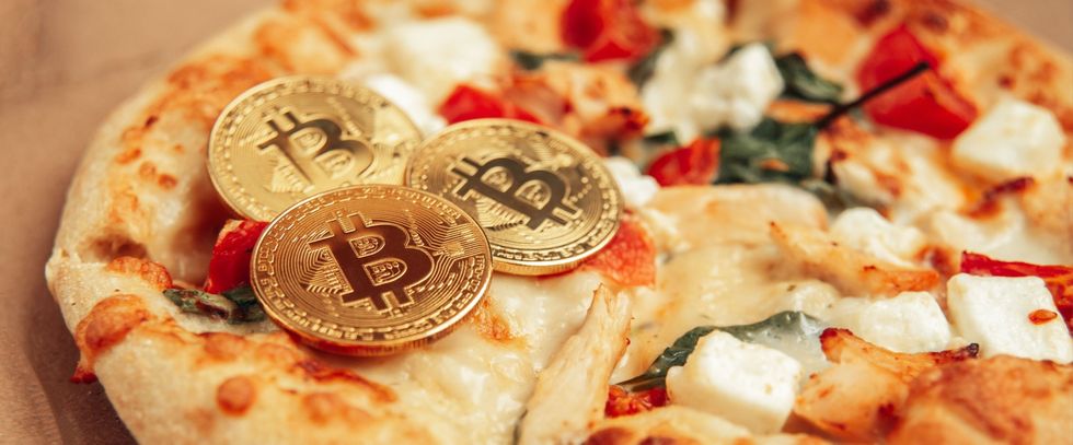 Three Bitcoin on top of a pizza to celebrate the first purchase with Bitcoin in 2010.