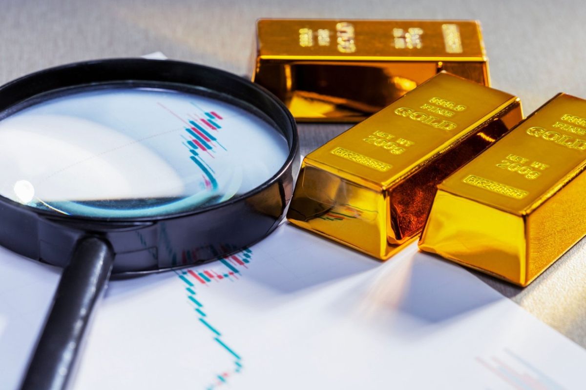 Three gold bars on price chart with magnifying glass.