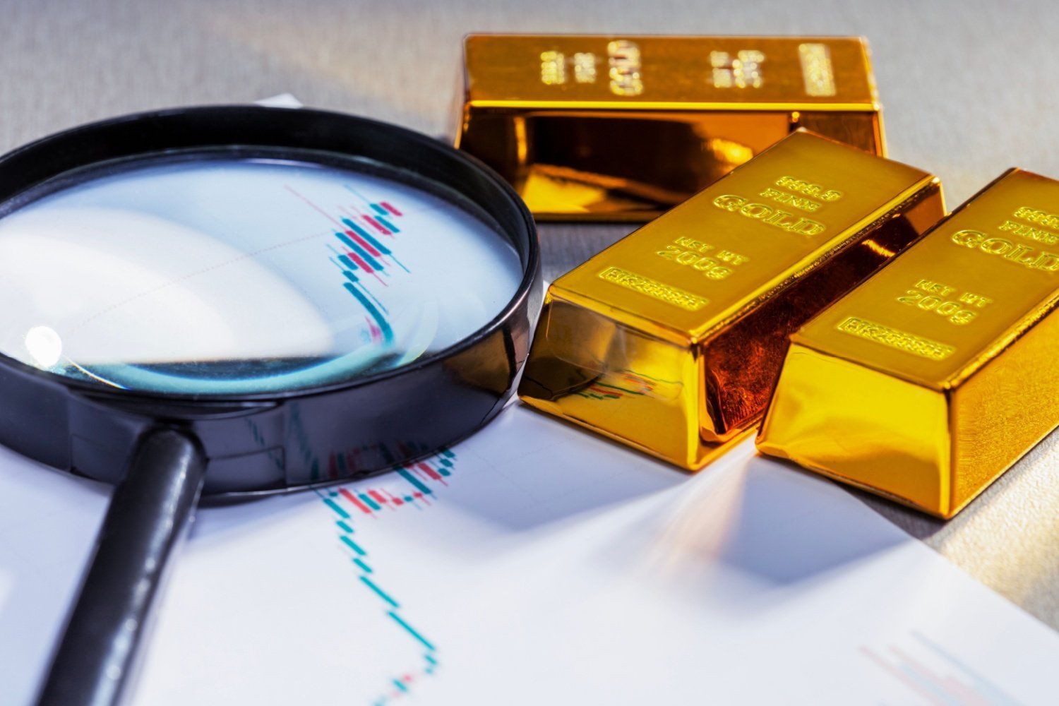 Three gold bars on price chart with magnifying glass.
