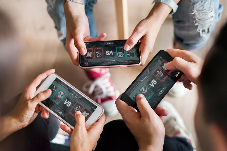 three people playing pure-skill mobile games together
