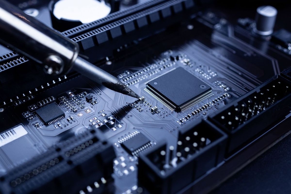 Tin being used to solder computer chip.