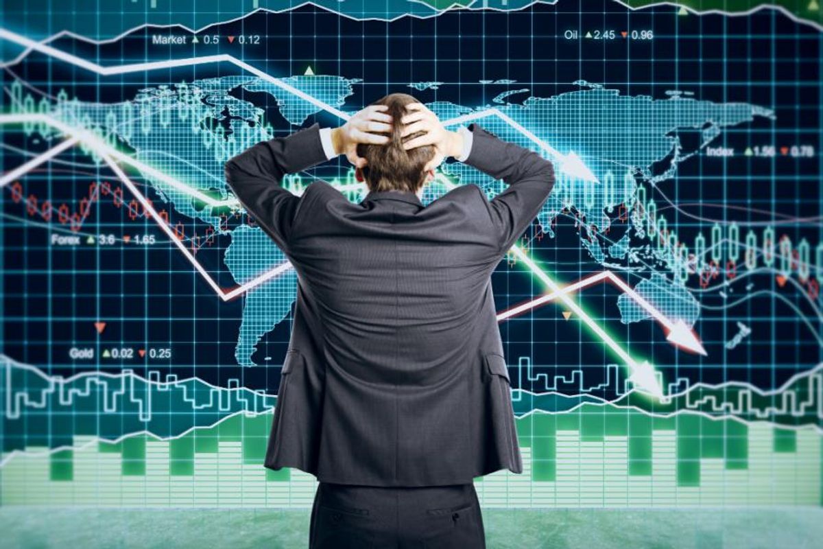 trader in front of crashing stock charts