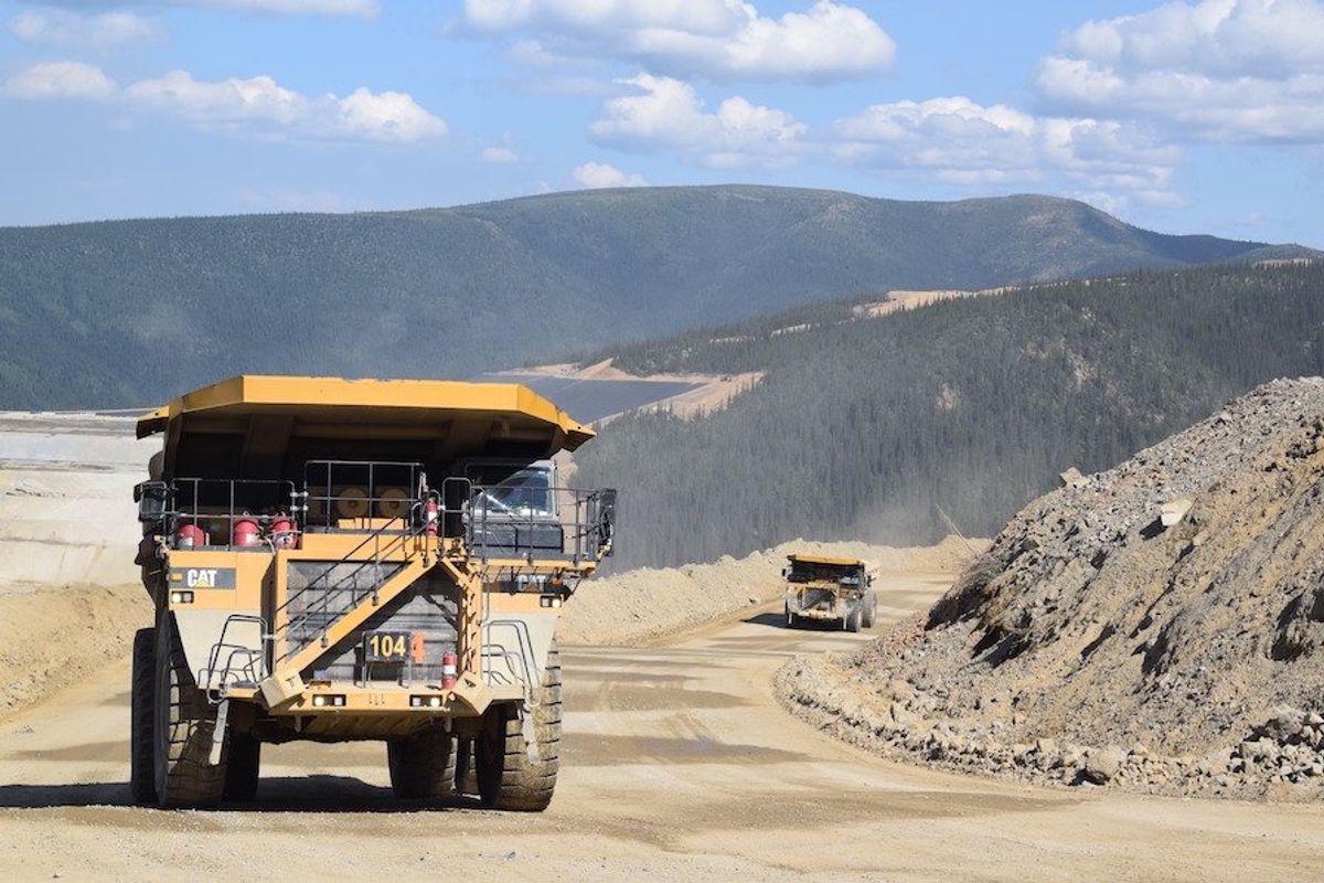 trucks driving through victoria gold site in the yukon