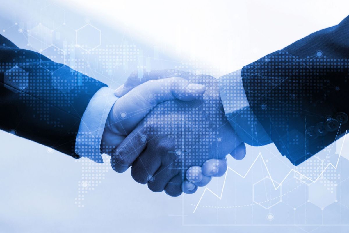 Two businesspeople shaking hands, overlayed with digital graphs and world map.