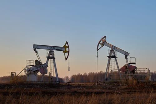 two oil well rigs in a field