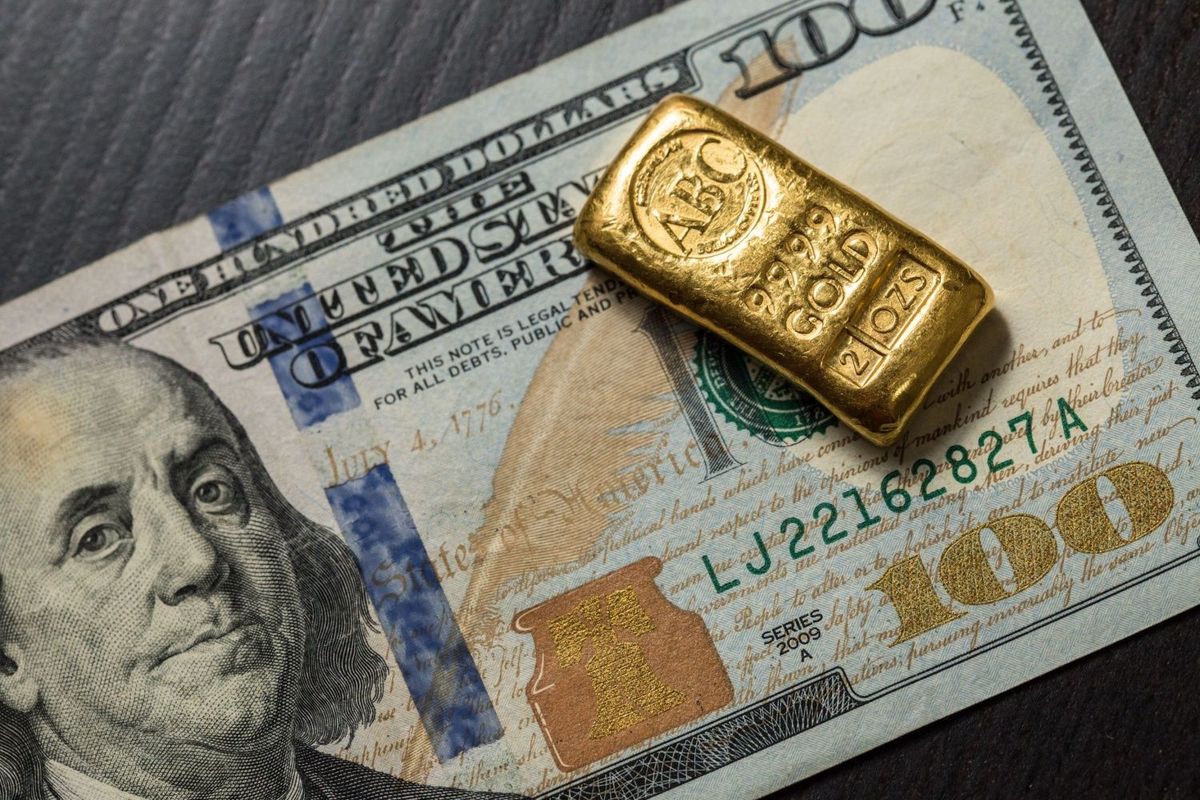 Two ounce gold bar with US$100 bill.