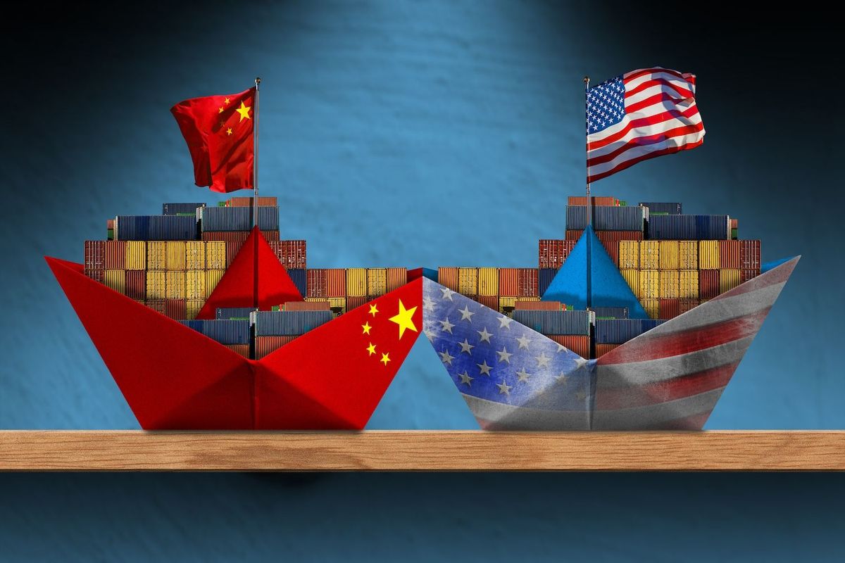 Two paper ships with cargo: China flag on left, US flag on right.