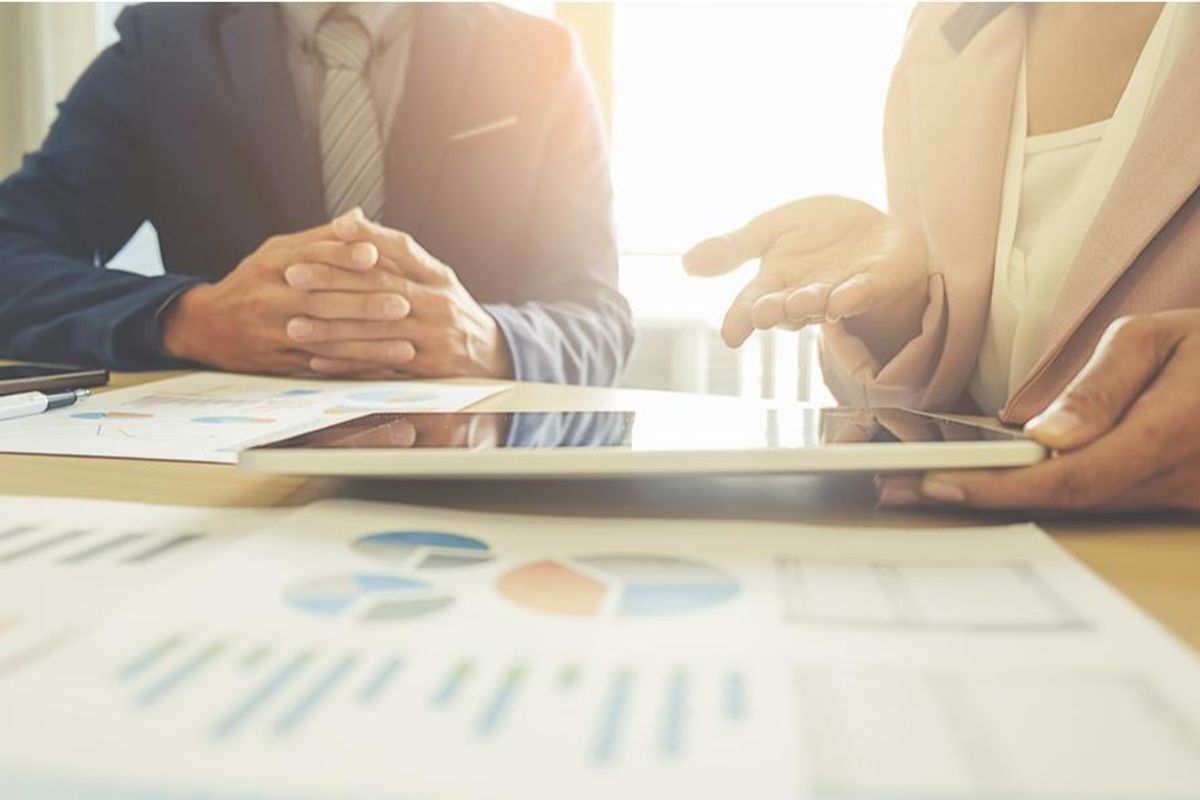 two people at business meeting evaluating financial results