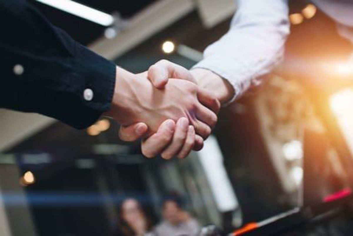 two people shaking hands in an agreement